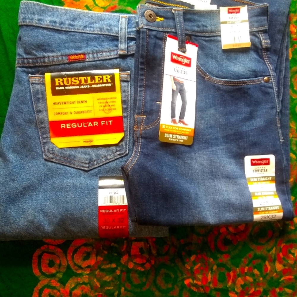 Two pairs one Rustler and one Wrangler men's jeans
